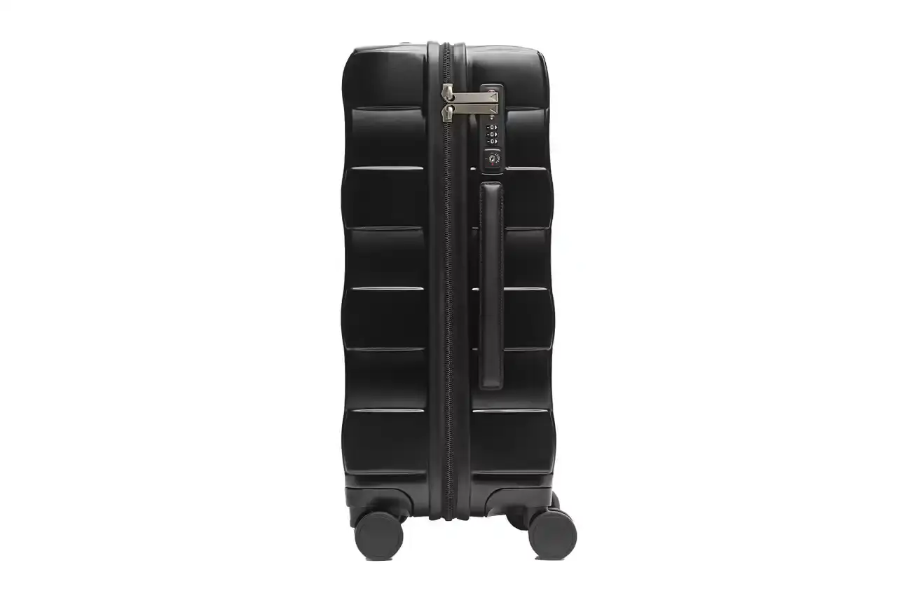 Bottega Veneta Bottega Veneta Odyssey carry-on suitcase with textured polycarbonate shell featuring 3D Intreccio pattern, silver hardware, and brown calfskin leather handles. The wheeled luggage is shown in a three-quarter view displaying its structured design and branded details. (image 4 of 7)