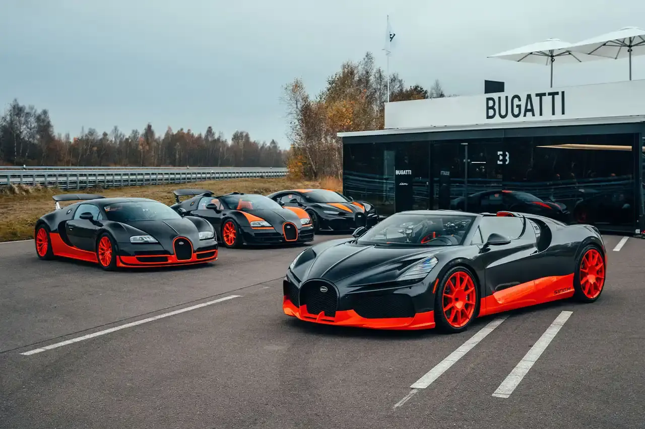 Bugatti Bugatti, the renowned manufacturer of high-performance luxury automobiles, has once again pushed the boundaries of automotive engineering with the remarkable achievements of its W16 Mistral model. On November 9th, the W16 Mistral set a new world record for the fastest open-top car, reaching a staggering speed of 453.91 km/h (281 mph) at the ATP Automotive Testing Papenburg track in Germany. The record-breaking run was piloted by Andy Wallace, Bugatti's official test driver and a renowned Le Mans winner, showcasing the exceptional capabilities of the W16 Mistral. This remarkable feat builds upon Bugatti's legacy of record-setting performance, including the Veyron 16.4 Grand Sport Vitesse's 408.84 km/h (253 mph) record achieved in 2013 and the Chiron Super Sport 300+'s 490.48 km/h (304 mph) closed-cockpit record set in 2019. The W16 Mistral, a bespoke $14.8 million USD model, features a striking black carbon body with "Jet Orange" accents, paying homage to Bugatti's previous record-setting vehicles. The event was attended by Mate Rimac, CEO of Bugatti Rimac, as well as Bugatti's senior team and the vehicle's owner, a collector from Punjab, India. Highlighting the W16 Mistral's prowess, the owner had the opportunity to experience the car's remarkable speed firsthand, joining Wallace for a high-speed run. This latest addition to The Singh Collection joins an exclusive lineup of Bugatti's record-breaking automobiles. (image 9 of 12)