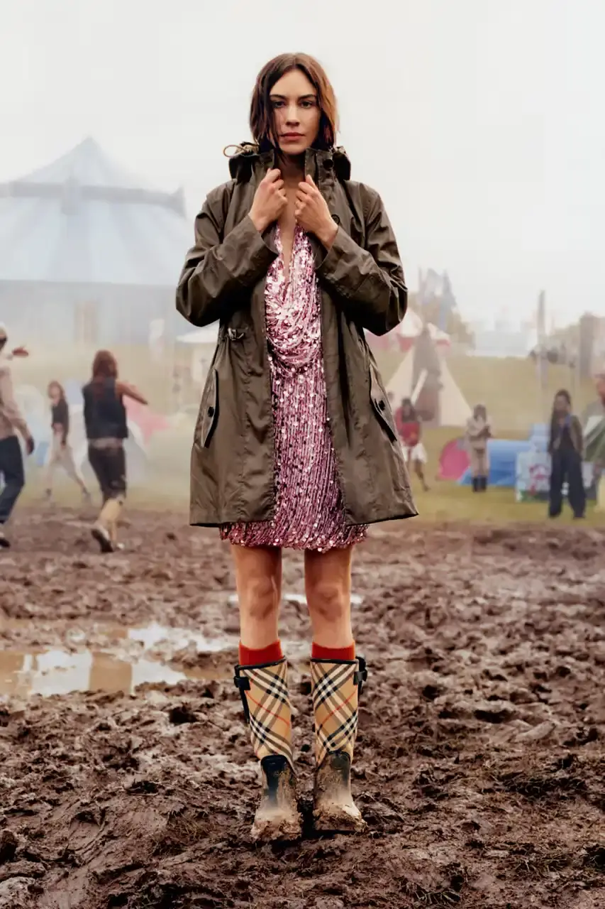 BURBERRY DROPS FESTIVAL COLLECTION FOR WEATHER EXTREMES image about Burberry's festival clothing collection designed for variable weather conditions. Covers campaign featuring multiple celebrities, product details including waterproof and lightweight options, and practical festival footwear. Content includes product descriptions, campaign visuals explanation, and shopping information for festival-goers seeking luxury outdoor wear. (image 26 of 31)