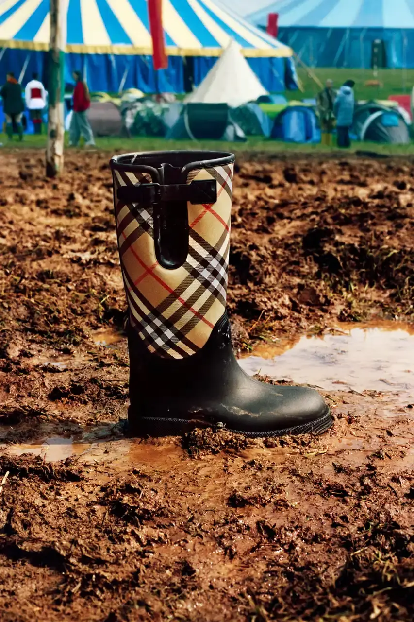 BURBERRY DROPS FESTIVAL COLLECTION FOR WEATHER EXTREMES image about Burberry's festival clothing collection designed for variable weather conditions. Covers campaign featuring multiple celebrities, product details including waterproof and lightweight options, and practical festival footwear. Content includes product descriptions, campaign visuals explanation, and shopping information for festival-goers seeking luxury outdoor wear. (image 5 of 31)