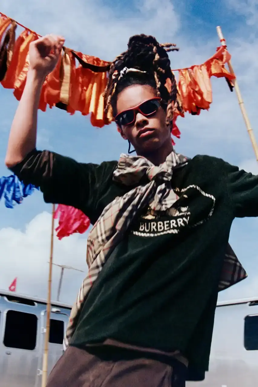 BURBERRY DROPS FESTIVAL COLLECTION FOR WEATHER EXTREMES image about Burberry's festival clothing collection designed for variable weather conditions. Covers campaign featuring multiple celebrities, product details including waterproof and lightweight options, and practical festival footwear. Content includes product descriptions, campaign visuals explanation, and shopping information for festival-goers seeking luxury outdoor wear. (image 17 of 31)