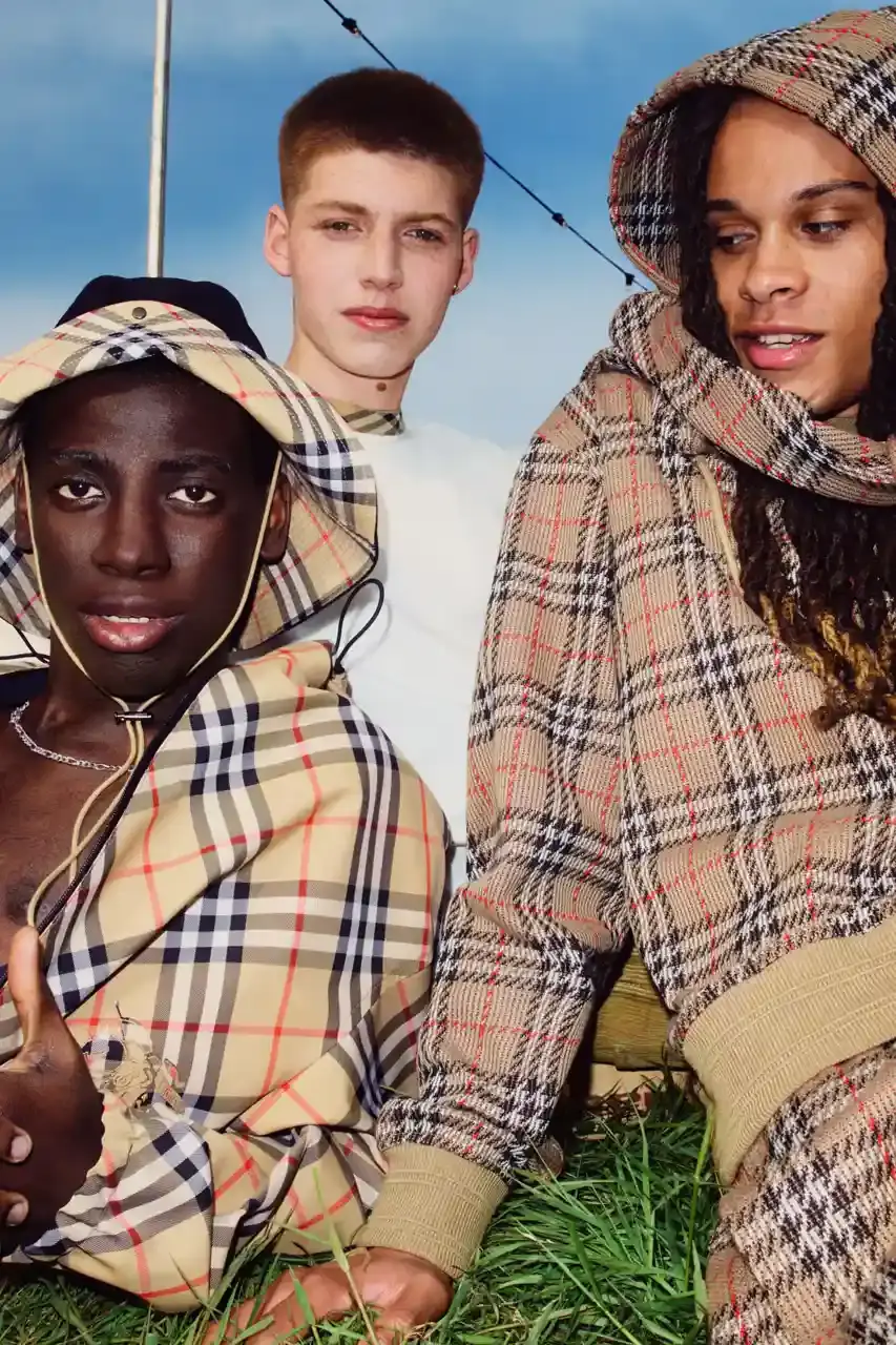 BURBERRY DROPS FESTIVAL COLLECTION FOR WEATHER EXTREMES image about Burberry's festival clothing collection designed for variable weather conditions. Covers campaign featuring multiple celebrities, product details including waterproof and lightweight options, and practical festival footwear. Content includes product descriptions, campaign visuals explanation, and shopping information for festival-goers seeking luxury outdoor wear. (image 16 of 31)