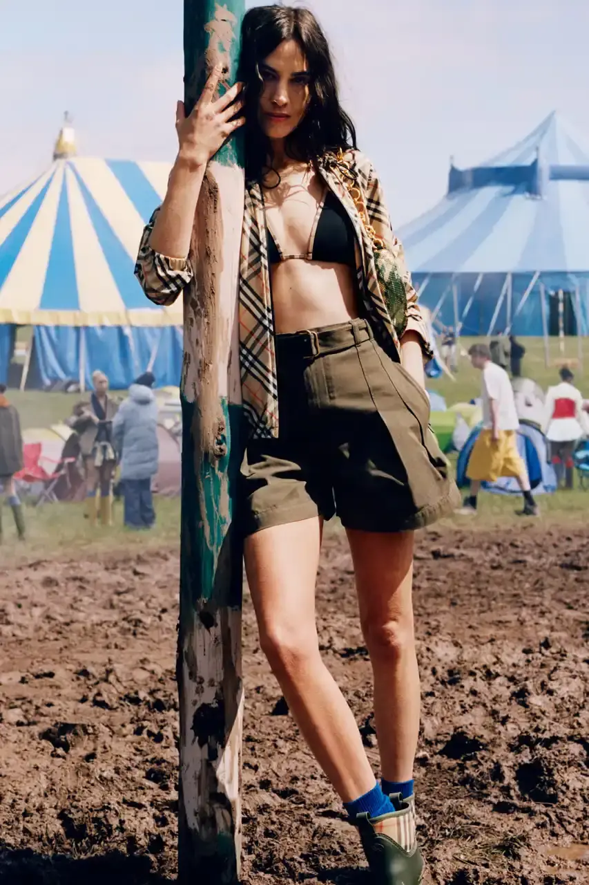 BURBERRY DROPS FESTIVAL COLLECTION FOR WEATHER EXTREMES image about Burberry's festival clothing collection designed for variable weather conditions. Covers campaign featuring multiple celebrities, product details including waterproof and lightweight options, and practical festival footwear. Content includes product descriptions, campaign visuals explanation, and shopping information for festival-goers seeking luxury outdoor wear. (image 12 of 31)