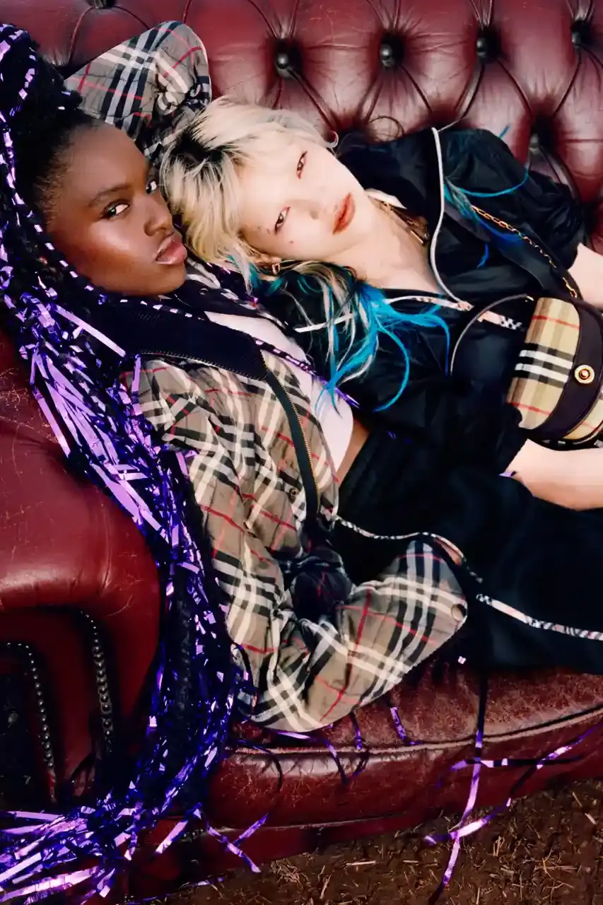 BURBERRY DROPS FESTIVAL COLLECTION FOR WEATHER EXTREMES image about Burberry's festival clothing collection designed for variable weather conditions. Covers campaign featuring multiple celebrities, product details including waterproof and lightweight options, and practical festival footwear. Content includes product descriptions, campaign visuals explanation, and shopping information for festival-goers seeking luxury outdoor wear. (image 13 of 31)