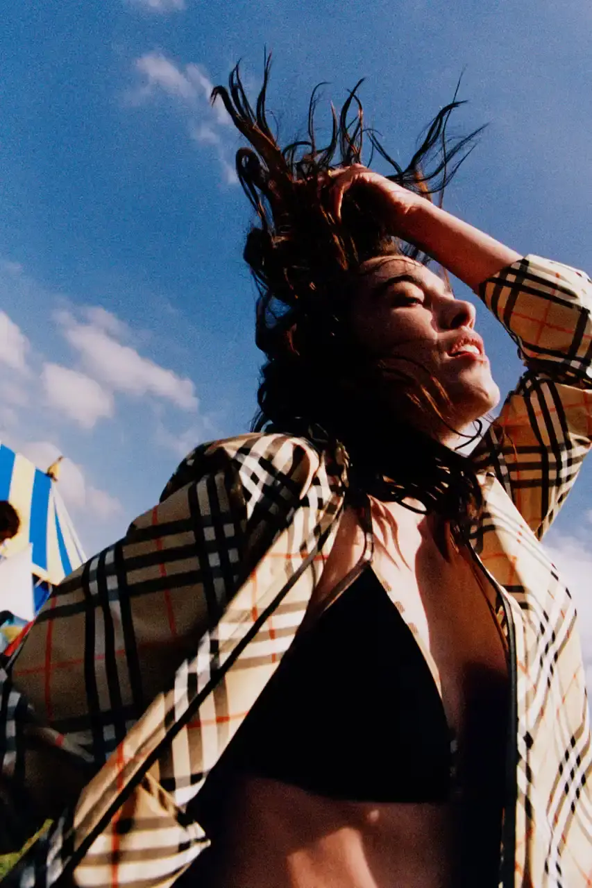 BURBERRY DROPS FESTIVAL COLLECTION FOR WEATHER EXTREMES image about Burberry's festival clothing collection designed for variable weather conditions. Covers campaign featuring multiple celebrities, product details including waterproof and lightweight options, and practical festival footwear. Content includes product descriptions, campaign visuals explanation, and shopping information for festival-goers seeking luxury outdoor wear. (image 11 of 31)