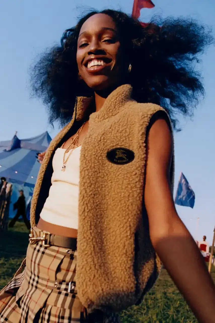 BURBERRY DROPS FESTIVAL COLLECTION FOR WEATHER EXTREMES image about Burberry's festival clothing collection designed for variable weather conditions. Covers campaign featuring multiple celebrities, product details including waterproof and lightweight options, and practical festival footwear. Content includes product descriptions, campaign visuals explanation, and shopping information for festival-goers seeking luxury outdoor wear. (image 31 of 31)
