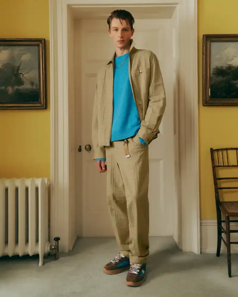 BURBERRY RETURNS TO HOUSE CODES FOR SPRING 2026 Article reviewing Burberry's Spring 2026 menswear collection, featuring heritage-inspired pieces including trench coats, knitwear, and accessories with signature house patterns. (image 10 of 19)