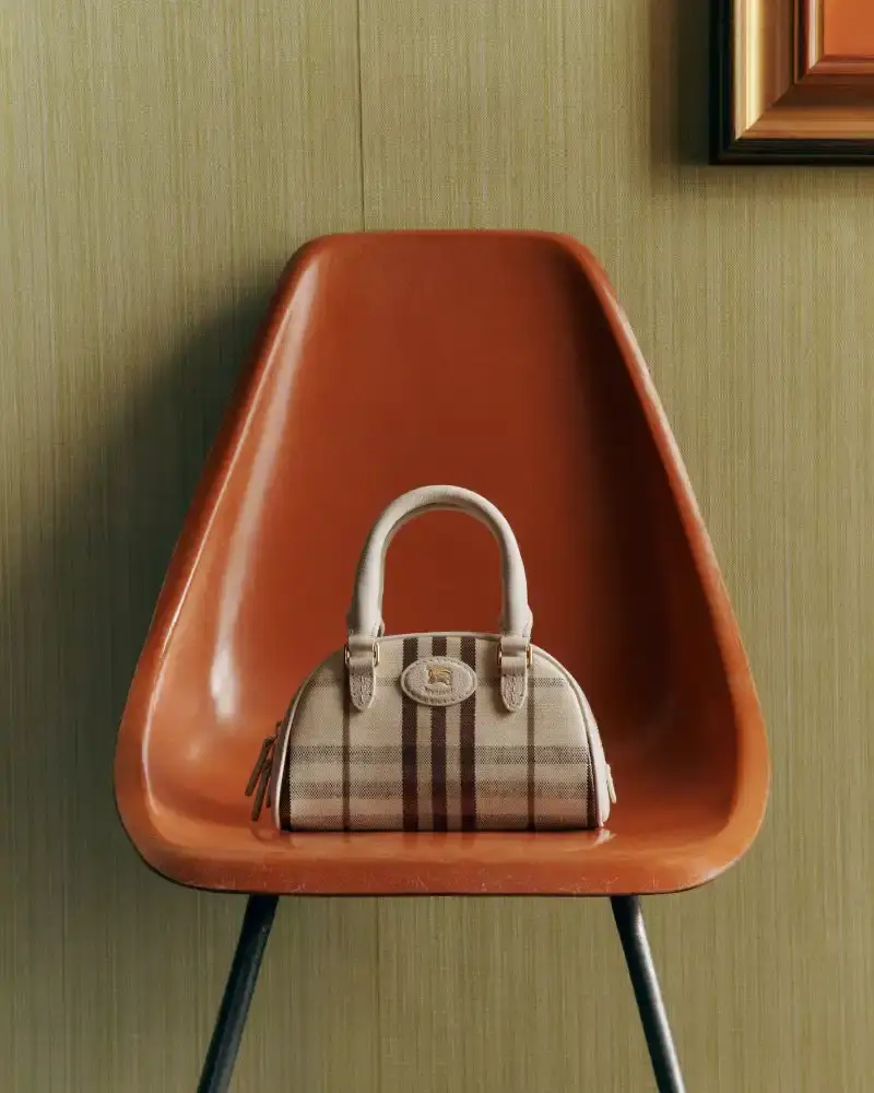 BURBERRY RETURNS TO HOUSE CODES FOR SPRING 2026 Article reviewing Burberry's Spring 2026 menswear collection, featuring heritage-inspired pieces including trench coats, knitwear, and accessories with signature house patterns. (image 17 of 19)