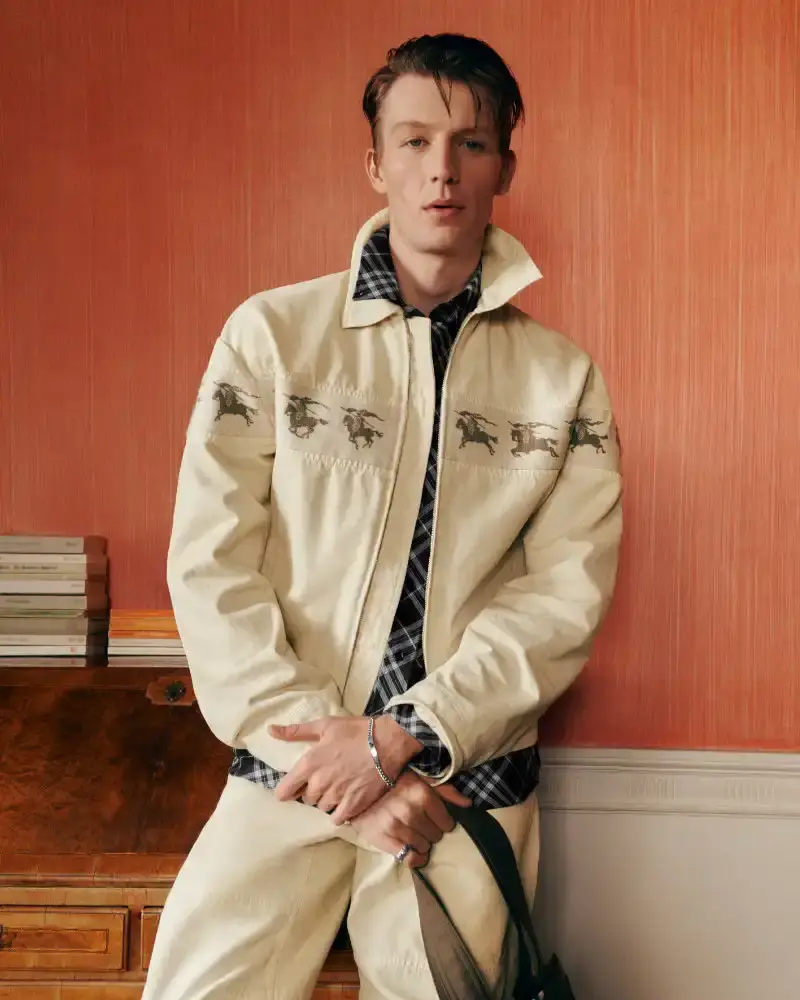 BURBERRY RETURNS TO HOUSE CODES FOR SPRING 2026 Article reviewing Burberry's Spring 2026 menswear collection, featuring heritage-inspired pieces including trench coats, knitwear, and accessories with signature house patterns. (image 4 of 19)