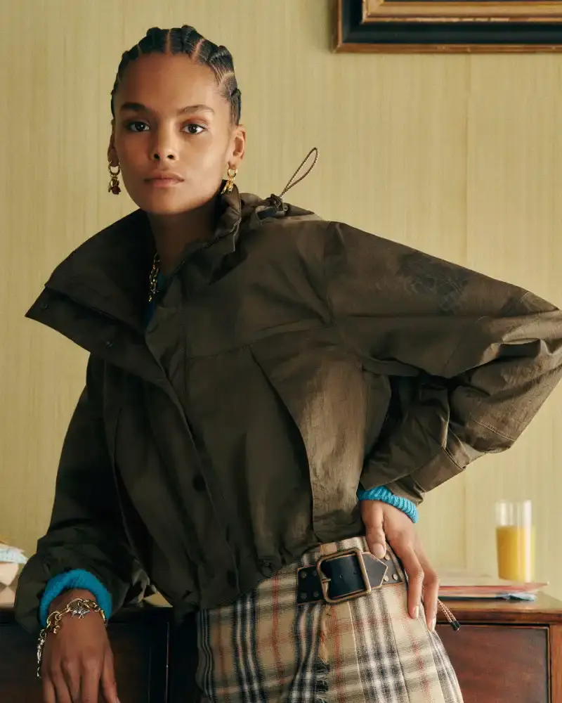 BURBERRY RETURNS TO HOUSE CODES FOR SPRING 2026 Article reviewing Burberry's Spring 2026 menswear collection, featuring heritage-inspired pieces including trench coats, knitwear, and accessories with signature house patterns. (image 3 of 19)