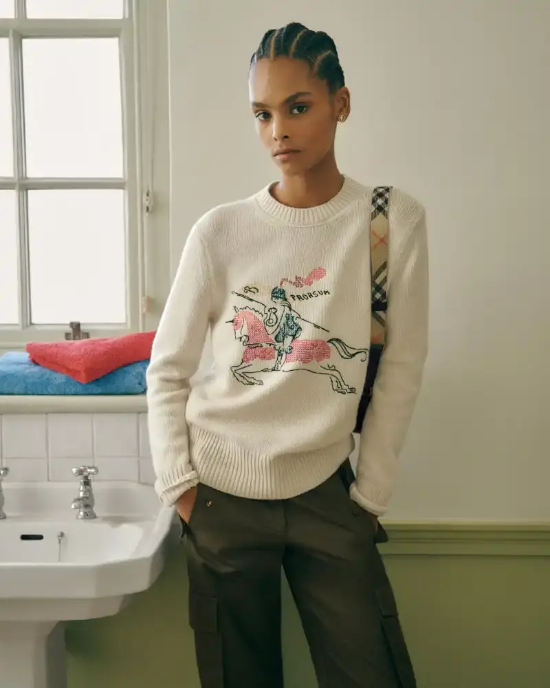 BURBERRY RETURNS TO HOUSE CODES FOR SPRING 2026 Article reviewing Burberry's Spring 2026 menswear collection, featuring heritage-inspired pieces including trench coats, knitwear, and accessories with signature house patterns. (image 11 of 19)