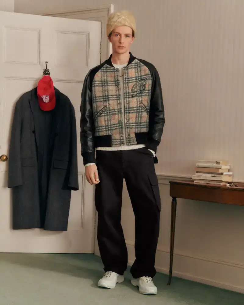 BURBERRY RETURNS TO HOUSE CODES FOR SPRING 2026 Article reviewing Burberry's Spring 2026 menswear collection, featuring heritage-inspired pieces including trench coats, knitwear, and accessories with signature house patterns. (image 12 of 19)