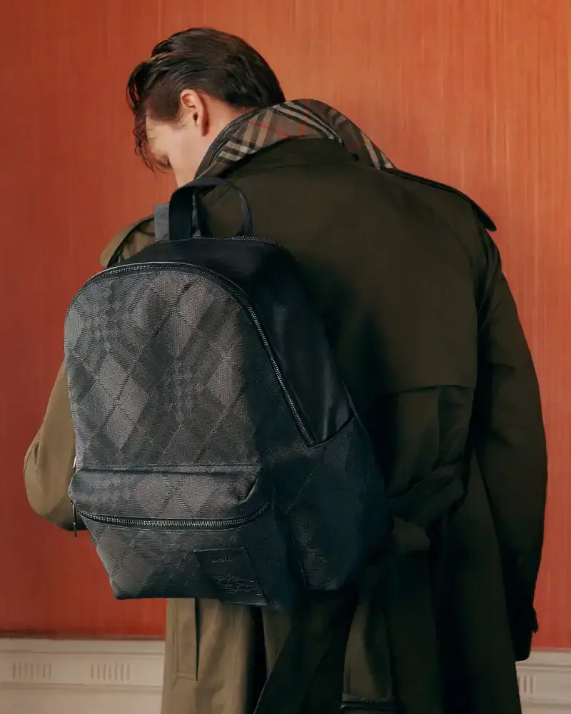 BURBERRY RETURNS TO HOUSE CODES FOR SPRING 2026 Article reviewing Burberry's Spring 2026 menswear collection, featuring heritage-inspired pieces including trench coats, knitwear, and accessories with signature house patterns. (image 8 of 19)