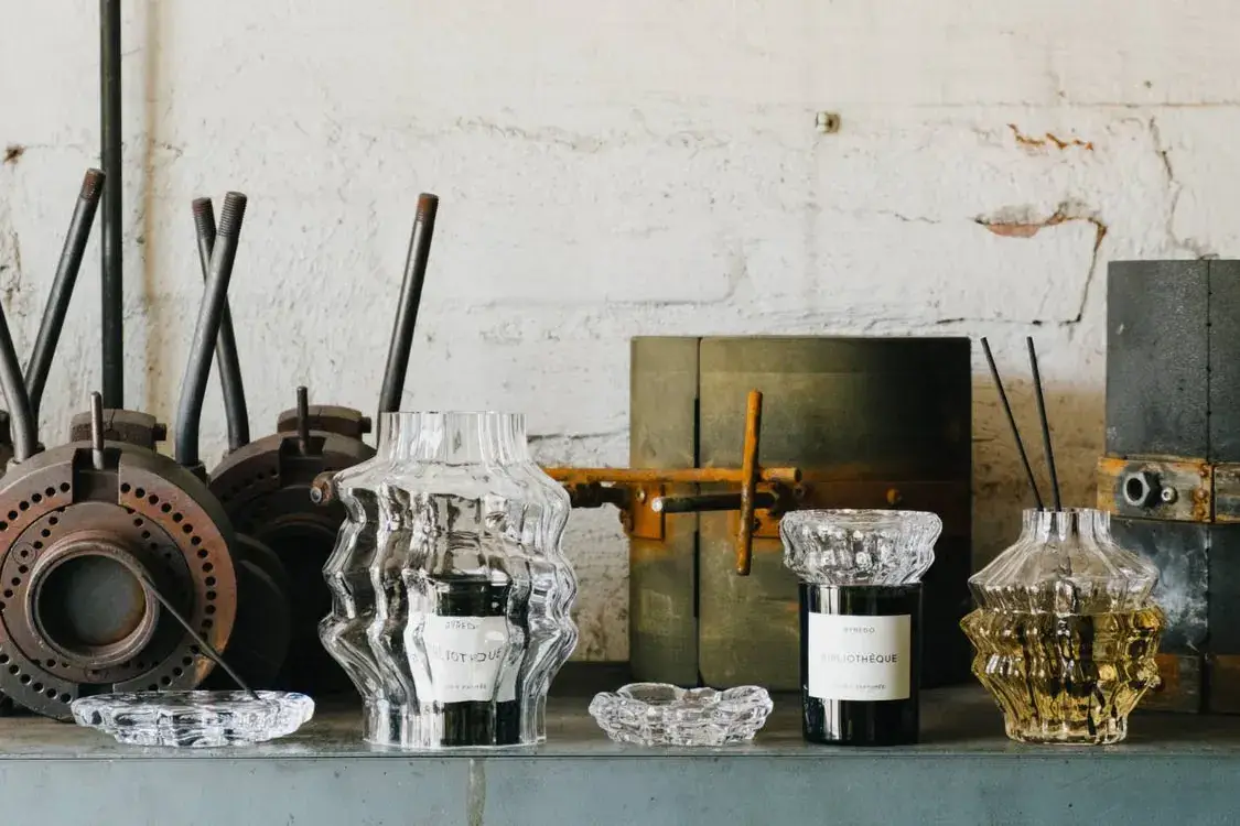 BYREDO AND IITTALA EXPAND LJUS INTO FIVE GLASS OBJECTS image of Byredo and Iittala launched the LJUS glass collection on October 16, 2026. The five handmade pieces cover candles, incense and fragrance and come from a factory in Finland.