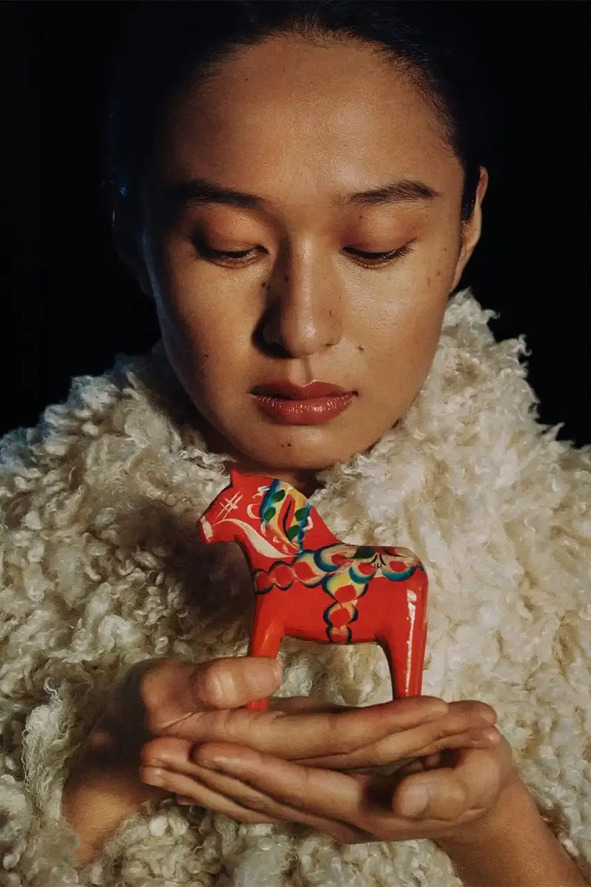 BYREDO MARKS LUNAR NEW YEAR WITH HORSE-THEMED CAMPAIGN Byredo releases Lunar New Year campaign featuring two fragrances, Rose of No Man's Land and Desert Dawn, photographed by Annie Lai with models Xi Yi and Wang Xuan in natural settings, drawing inspiration from Swedish Dala horse symbolism. (image 3 of 4)