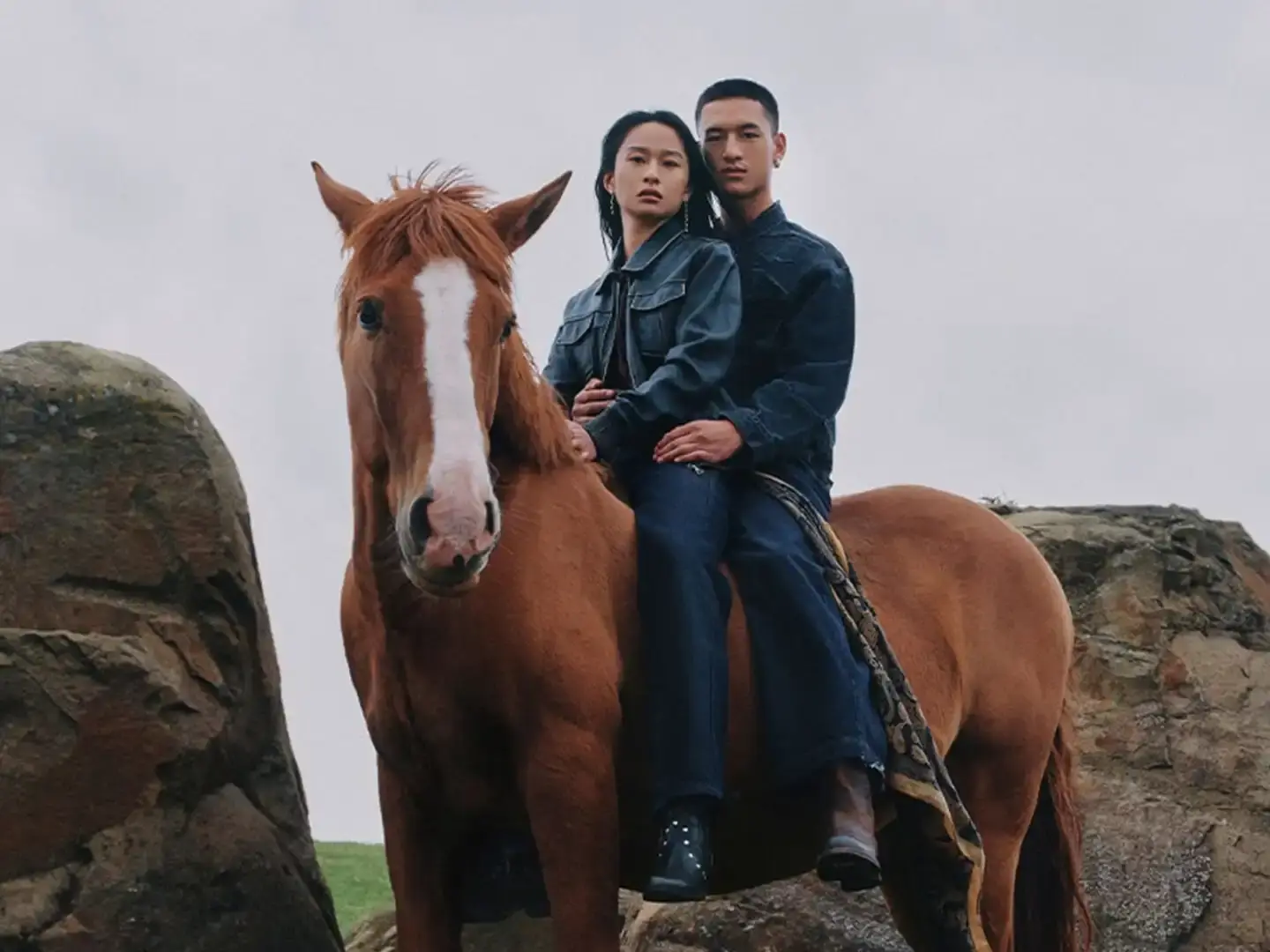 Byredo releases Lunar New Year campaign featuring two fragrances, Rose of No Man's Land and Desert Dawn, photographed by Annie Lai with models Xi Yi and Wang Xuan in natural settings, drawing inspiration from Swedish Dala horse symbolism.