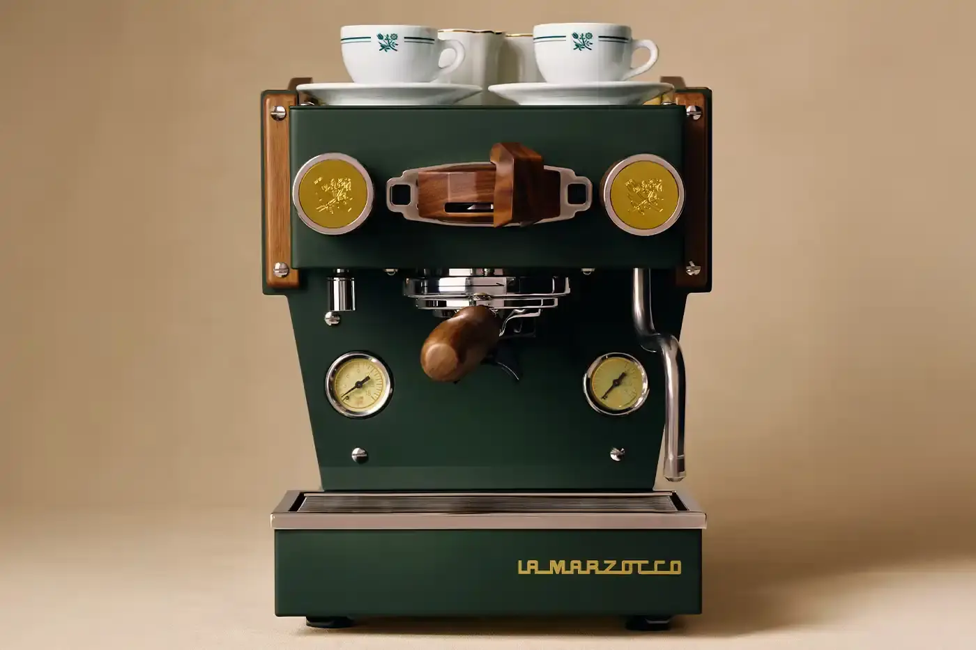 CAFÉ LEON DORE PARTNERS WITH LA MARZOCCO ON EXCLUSIVE COFFEE COLLECTION Image of the collaboration between Café Leon Dore (part of Aimé Leon Dore) and La Marzocco. The partnership features a custom-designed Linea Micra espresso machine in green with brass and walnut details, plus co-branded apparel including aprons, t-shirts, and hats. The collection is available exclusively through Aimé Leon Dore's stores and website. The article provides details about the machine's professional capabilities despite its compact size, and notes that it's being produced in limited quantities. (image 2 of 6)