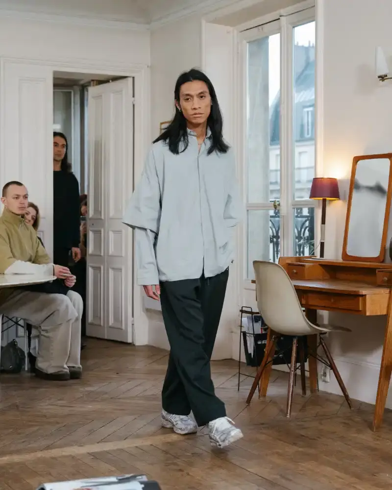 CAMIEL FORTGENS REWORKS DOMESTIC MATERIALS FOR FW26 Camiel Fortgens Fall/Winter 2026 collection shown in Paris apartment, featuring garments made from domestic materials like curtain pleats and sofa leather in earthy tones. (image 18 of 19)