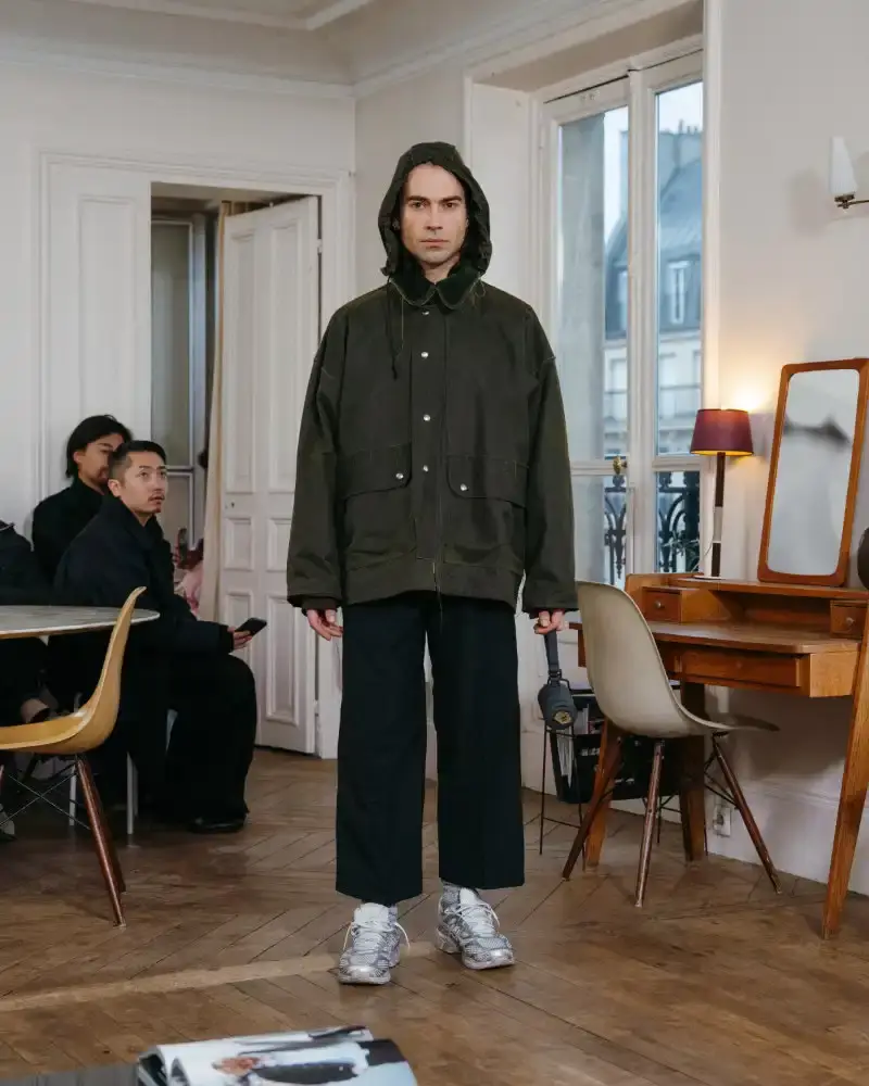 CAMIEL FORTGENS REWORKS DOMESTIC MATERIALS FOR FW26 Camiel Fortgens Fall/Winter 2026 collection shown in Paris apartment, featuring garments made from domestic materials like curtain pleats and sofa leather in earthy tones. (image 3 of 19)