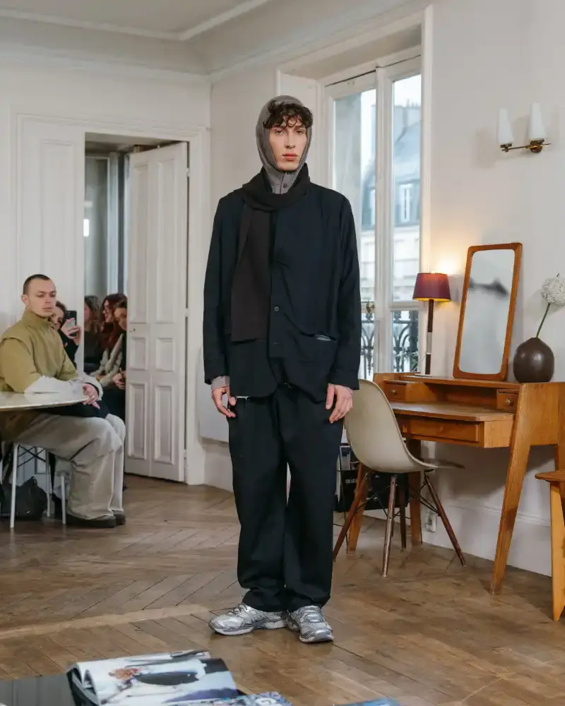 CAMIEL FORTGENS REWORKS DOMESTIC MATERIALS FOR FW26 Camiel Fortgens Fall/Winter 2026 collection shown in Paris apartment, featuring garments made from domestic materials like curtain pleats and sofa leather in earthy tones. (image 13 of 19)