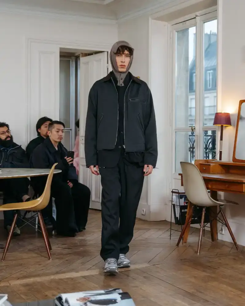 CAMIEL FORTGENS REWORKS DOMESTIC MATERIALS FOR FW26 Camiel Fortgens Fall/Winter 2026 collection shown in Paris apartment, featuring garments made from domestic materials like curtain pleats and sofa leather in earthy tones. (image 7 of 19)