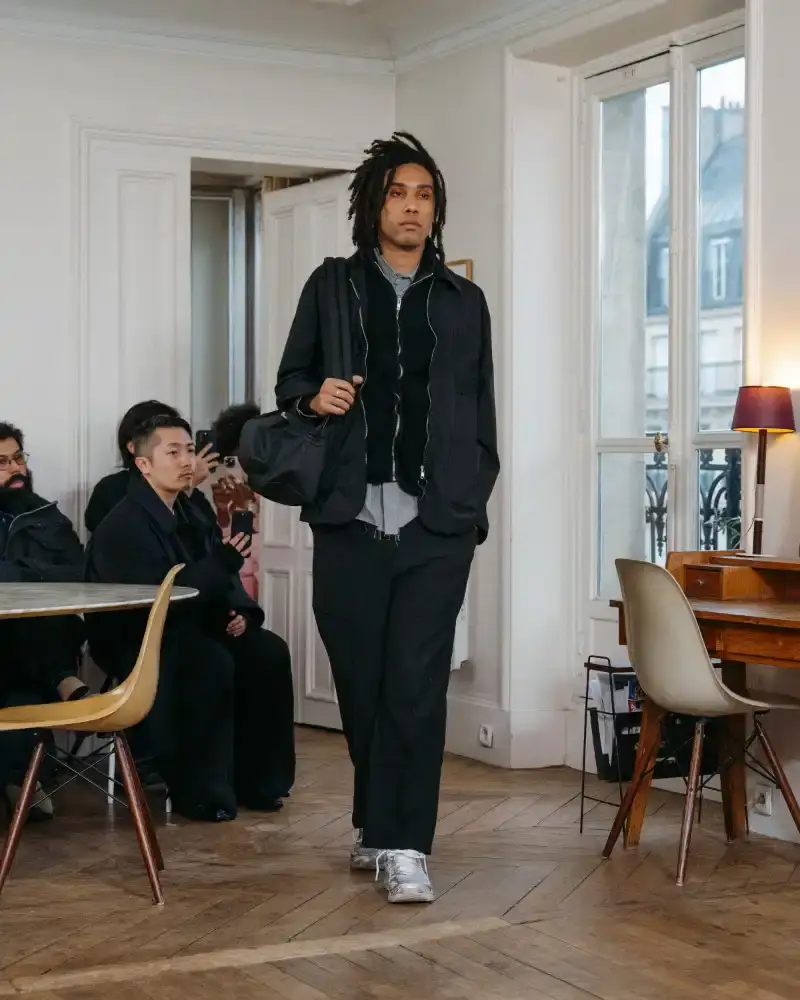 CAMIEL FORTGENS REWORKS DOMESTIC MATERIALS FOR FW26 Camiel Fortgens Fall/Winter 2026 collection shown in Paris apartment, featuring garments made from domestic materials like curtain pleats and sofa leather in earthy tones. (image 10 of 19)