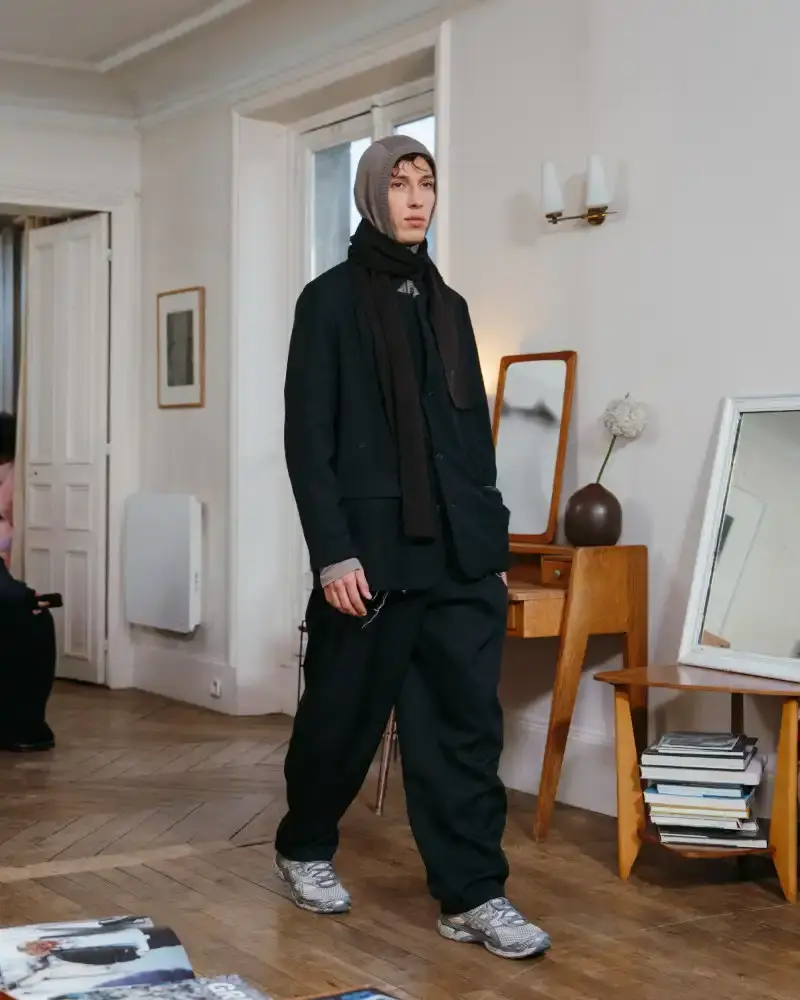 CAMIEL FORTGENS REWORKS DOMESTIC MATERIALS FOR FW26 Camiel Fortgens Fall/Winter 2026 collection shown in Paris apartment, featuring garments made from domestic materials like curtain pleats and sofa leather in earthy tones. (image 2 of 19)
