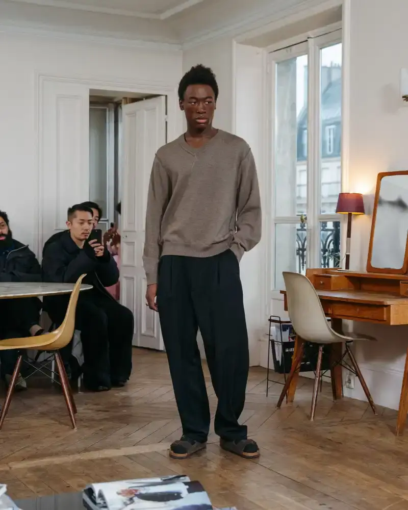 CAMIEL FORTGENS REWORKS DOMESTIC MATERIALS FOR FW26 Camiel Fortgens Fall/Winter 2026 collection shown in Paris apartment, featuring garments made from domestic materials like curtain pleats and sofa leather in earthy tones. (image 12 of 19)