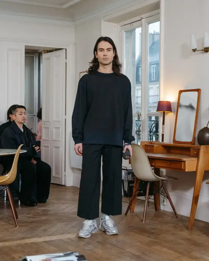 CAMIEL FORTGENS REWORKS DOMESTIC MATERIALS FOR FW26 Camiel Fortgens Fall/Winter 2026 collection shown in Paris apartment, featuring garments made from domestic materials like curtain pleats and sofa leather in earthy tones. (image 8 of 19)