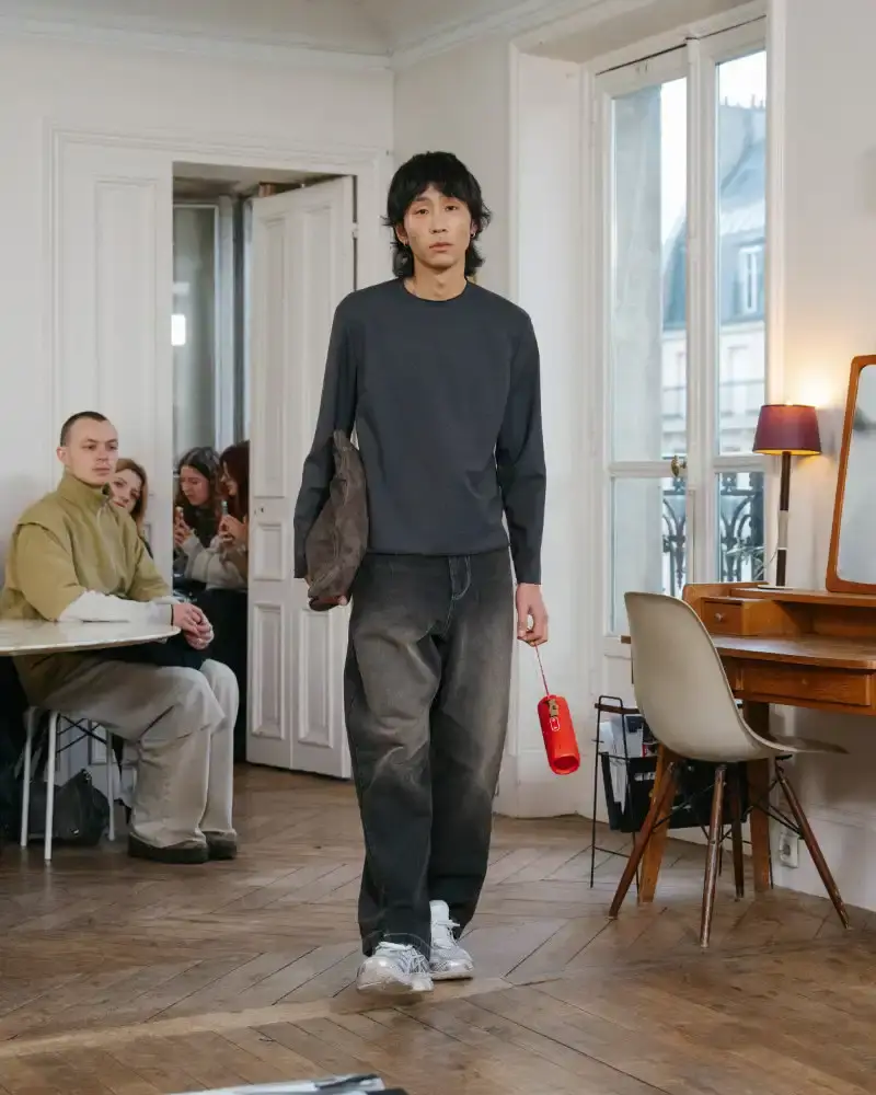 CAMIEL FORTGENS REWORKS DOMESTIC MATERIALS FOR FW26 Camiel Fortgens Fall/Winter 2026 collection shown in Paris apartment, featuring garments made from domestic materials like curtain pleats and sofa leather in earthy tones. (image 19 of 19)