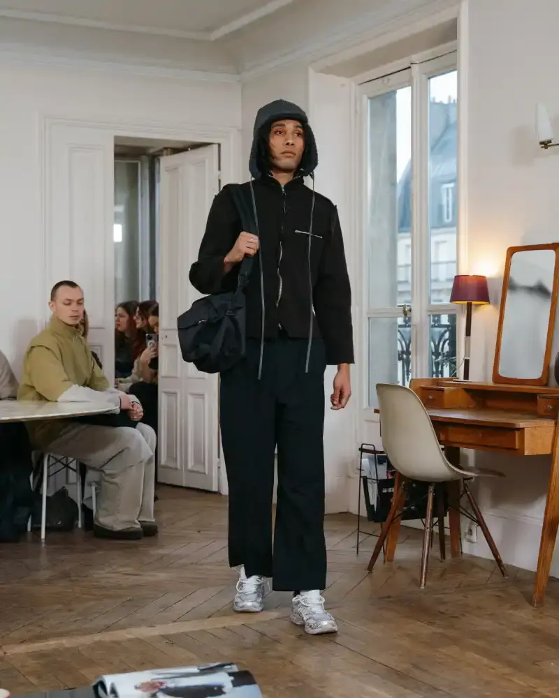 CAMIEL FORTGENS REWORKS DOMESTIC MATERIALS FOR FW26 Camiel Fortgens Fall/Winter 2026 collection shown in Paris apartment, featuring garments made from domestic materials like curtain pleats and sofa leather in earthy tones. (image 16 of 19)
