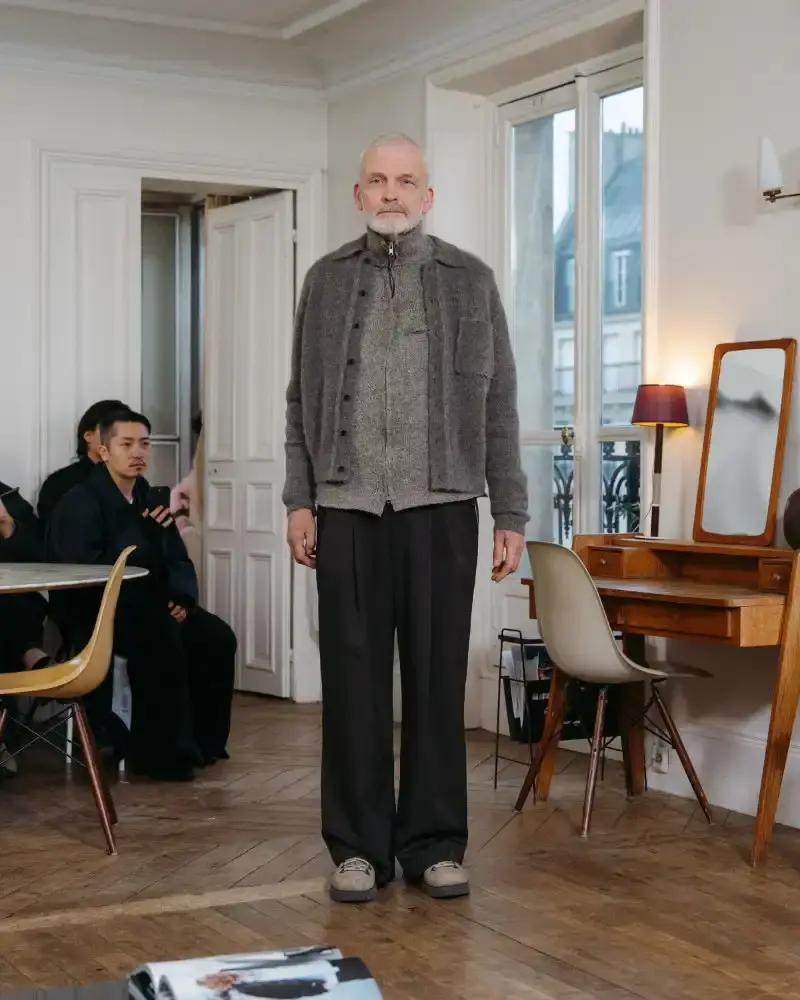 CAMIEL FORTGENS REWORKS DOMESTIC MATERIALS FOR FW26 Camiel Fortgens Fall/Winter 2026 collection shown in Paris apartment, featuring garments made from domestic materials like curtain pleats and sofa leather in earthy tones. (image 6 of 19)