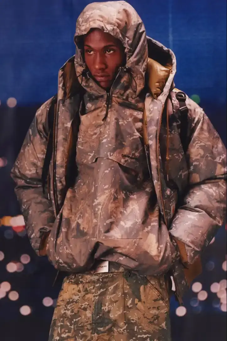 CARHARTT WIP FW25 FEATURES CAMO AND RICH COLORS image about Carhartt WIP's Fall 2025 collection featuring camouflage patterns and rich color tones in workwear designs. (image 2 of 20)