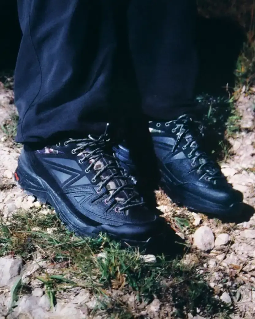 CARHARTT WIP AND SALOMON RELEASE X-ALP SNEAKER Carhartt WIP and Salomon collaborate on the X-ALP sneaker, featuring black leather upper with suede layers and camouflage details, releasing December 18. (image 4 of 6)