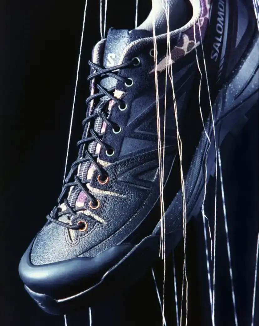 CARHARTT WIP AND SALOMON RELEASE X-ALP SNEAKER Carhartt WIP and Salomon collaborate on the X-ALP sneaker, featuring black leather upper with suede layers and camouflage details, releasing December 18. (image 5 of 6)