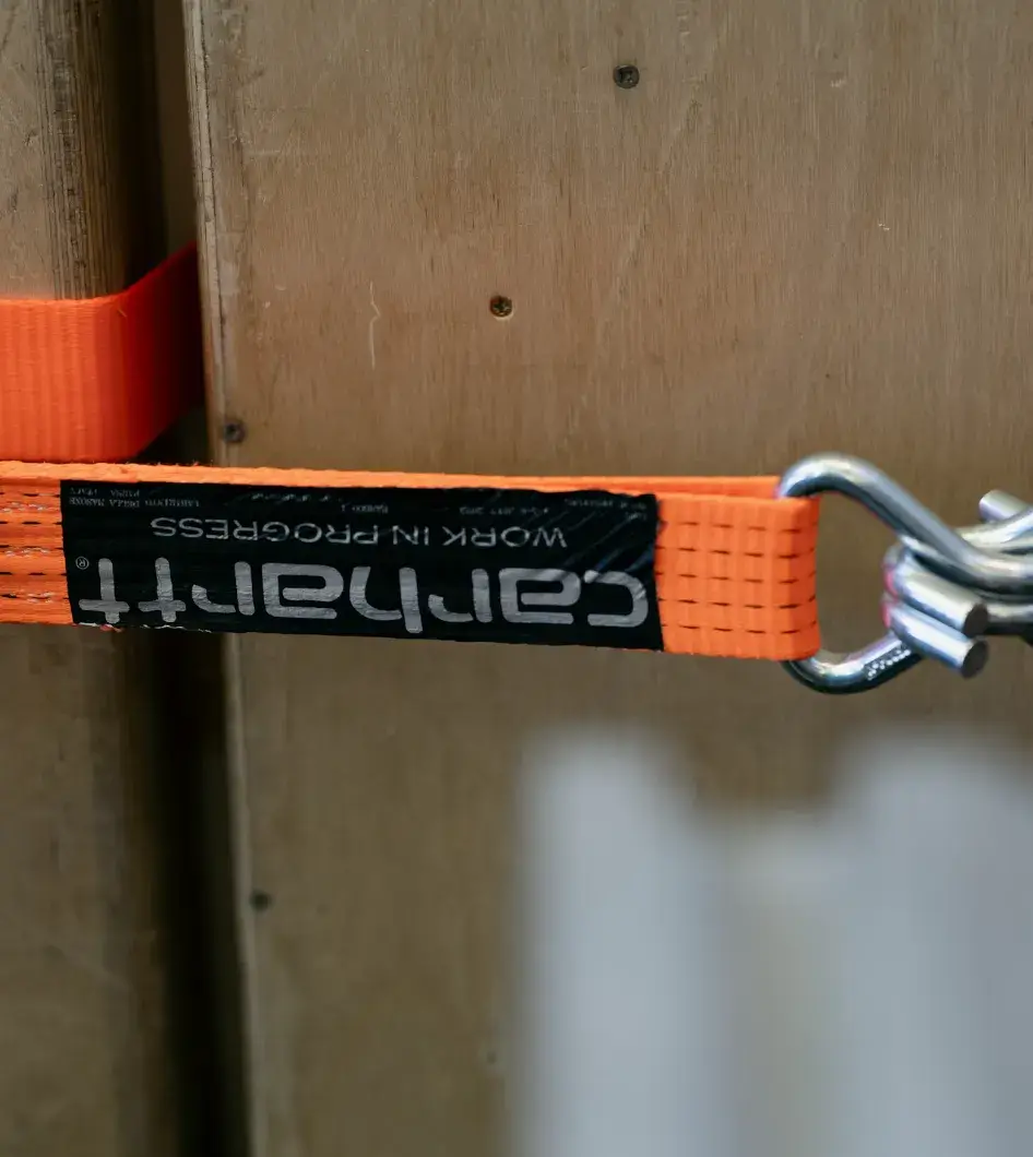 CARHARTT WIP JOINS USV AT LOST FESTIVAL 2026 A stacked wall of custom wooden speakers sits outdoors, featuring the Carhartt C logo on the grilles held together by orange straps. image by Stefano Mattea (image 2 of 4)