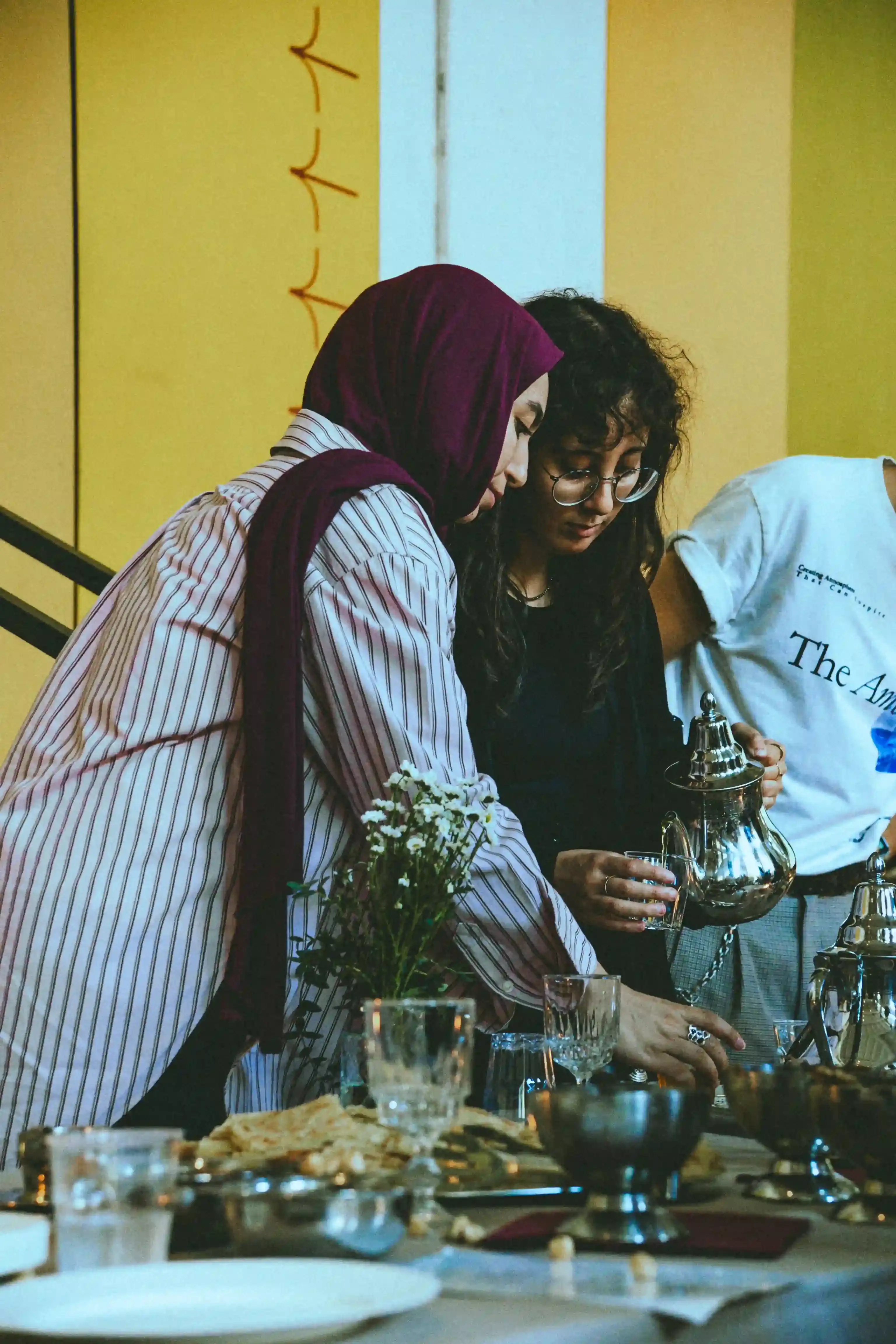 CASAWI & DARNA: MOROCCAN BRUNCH MEETS SWANA CINEMA IN MILAN image photographed by Alioune Gueye about a cultural event in Milan where fashion brand Casawi partnered with film festival Darna to host a Moroccan brunch followed by screenings of films from South West Asia and North Africa. The event brought together Milan's fashion and art community to emphasize authentic cultural connection over commercial spectacle, featuring traditional foods like Tunisian tea and fostering dialogue about identity and belonging through cinema. (image 5 of 16)