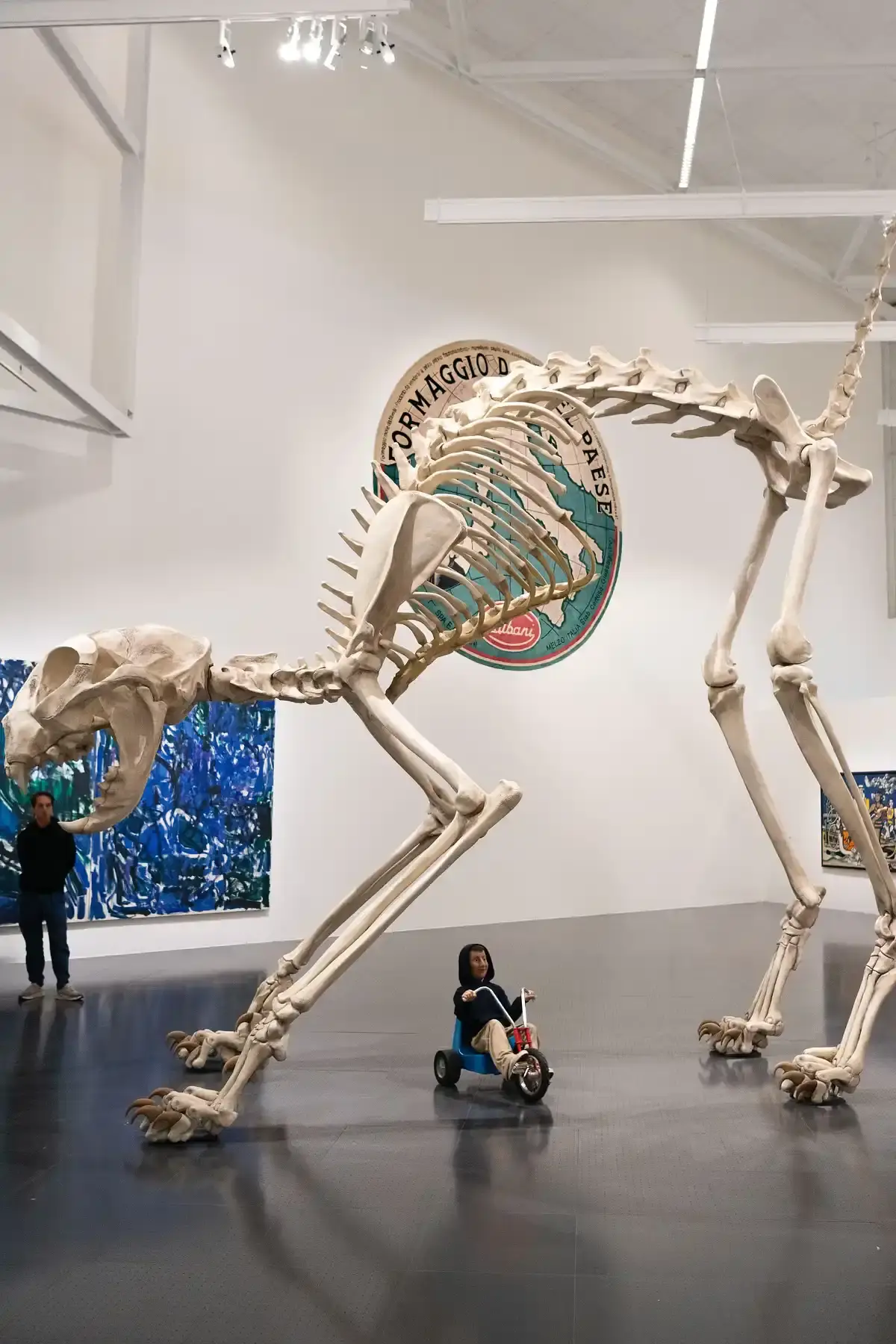 CATTELAN TAKES OVER POMPIDOU-METZ FOR 15TH ANNIVERSARY image of the Centre Pompidou-Metz's 15th anniversary exhibition "The Endless Sunday," curated by Maurizio Cattelan. It details how the Italian artist has filled all museum spaces with over 400 works from the Centre Pompidou collection alongside 30 of his own pieces, including the famous banana artwork "Comedian." The exhibition is organized as a 27-part alphabet with themes connected to literature and film, and will run until February 2027. Contact information for the museum in Metz, France is provided. (image 8 of 10)