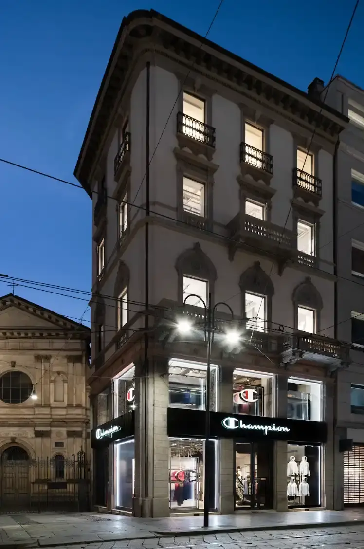 CHAMPION OPENS MILAN FLAGSHIP STORE Article about Champion's new Milan flagship store opening on Via Torino 19, with details on store layout, design concept, and community initiatives.