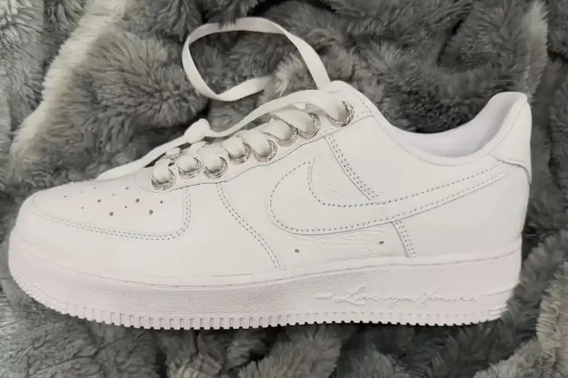 CHROME HEARTS X NOCTA X NIKE AIR FORCE 1 LOW Triple collaboration sneaker featuring white leather construction with sterling silver hardware and engraved metal components.
