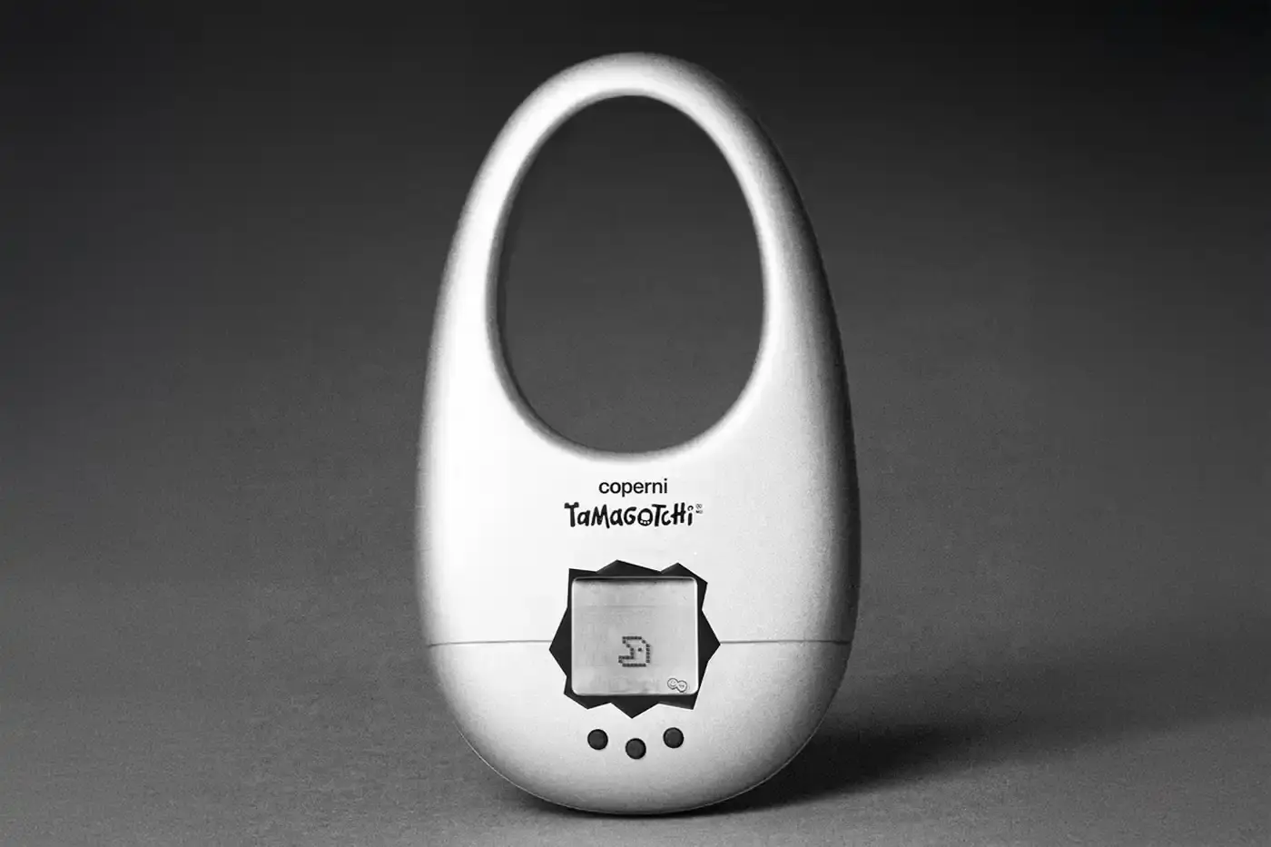 Coperni Small handbag in the shape of Coperni's signature Swipe design, modified to include a Tamagotchi digital pet display, available in navy, black and silver. (image 1 of 4)
