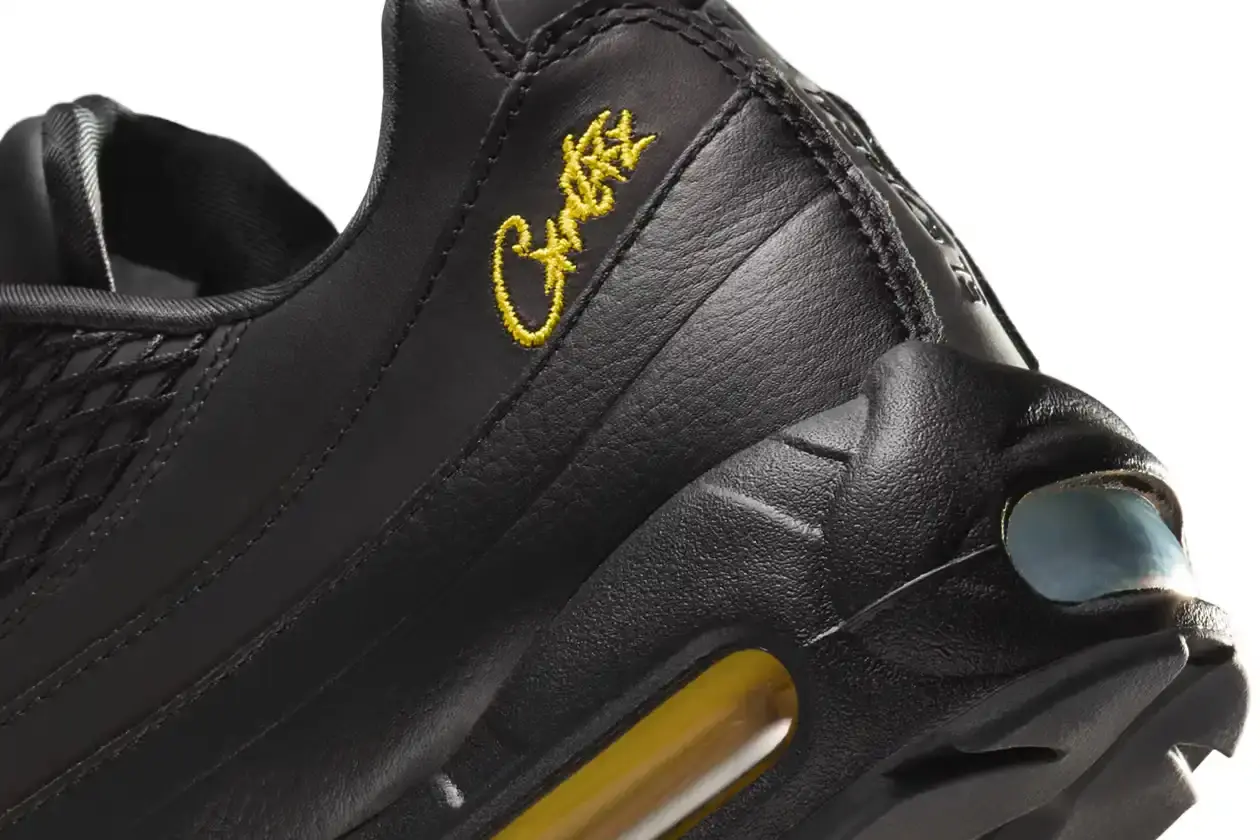 Nike Corteiz x Nike Air Max 95 'Honey Black' sneaker featuring an all-black premium leather upper with contrasting Tour Yellow accents on the branding and Air cushioning units. The sleek design showcases Corteiz branding on the lateral toe, heel, tongue and outsole, with London coordinates visible on the heel. The shoe maintains the Air Max 95's signature layered construction with mesh detailing on the upper. (image 8 of 8)