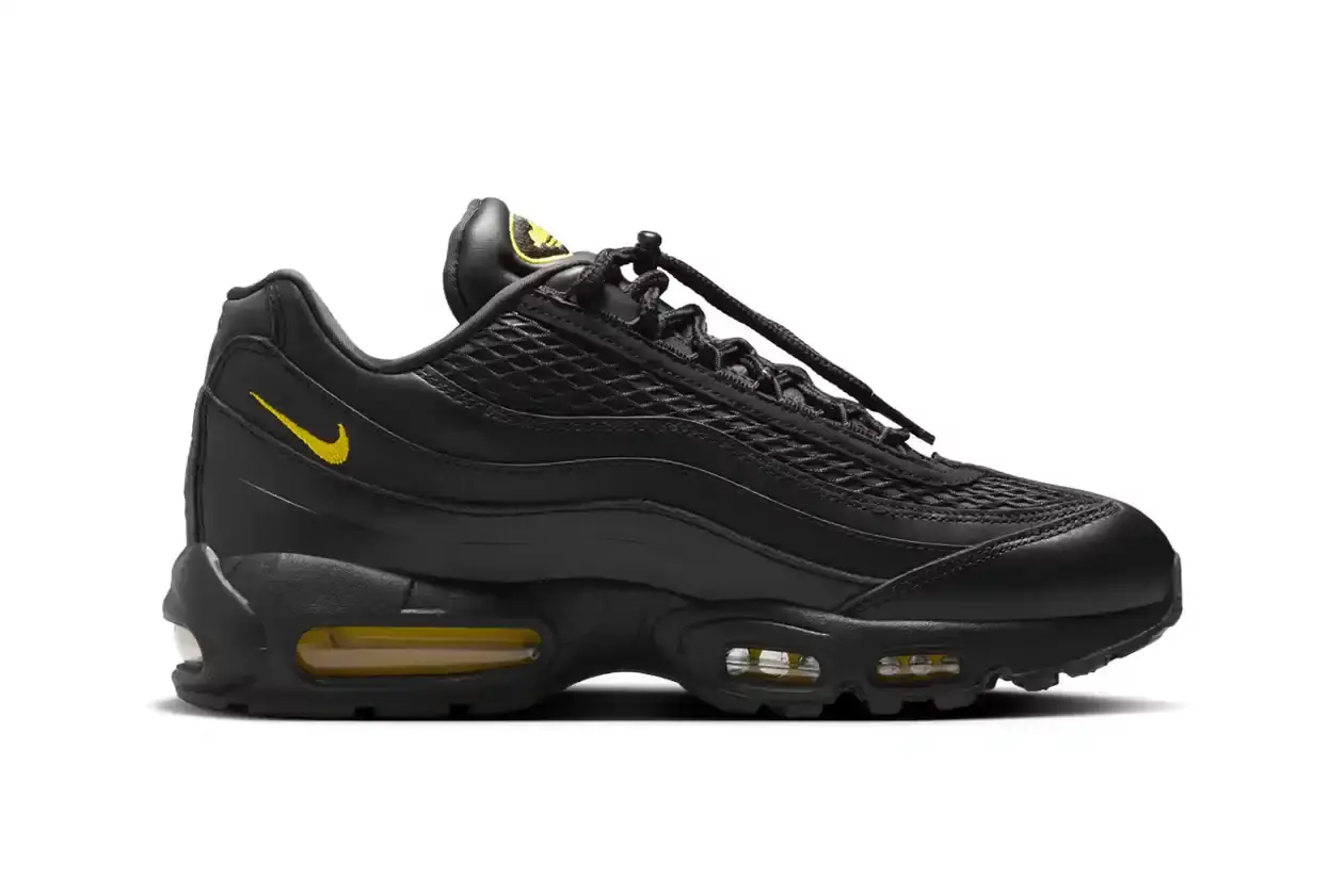 Nike Corteiz x Nike Air Max 95 'Honey Black' sneaker featuring an all-black premium leather upper with contrasting Tour Yellow accents on the branding and Air cushioning units. The sleek design showcases Corteiz branding on the lateral toe, heel, tongue and outsole, with London coordinates visible on the heel. The shoe maintains the Air Max 95's signature layered construction with mesh detailing on the upper. (image 3 of 8)