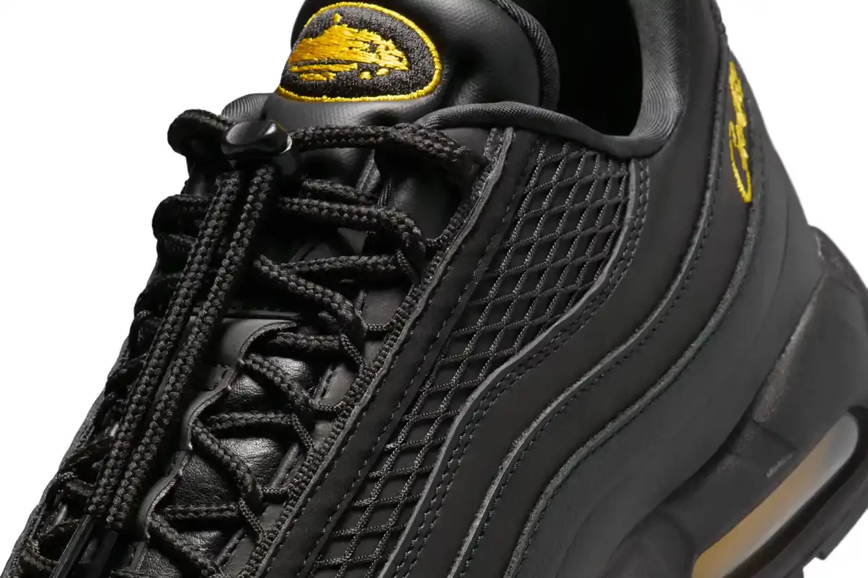 Nike Corteiz x Nike Air Max 95 'Honey Black' sneaker featuring an all-black premium leather upper with contrasting Tour Yellow accents on the branding and Air cushioning units. The sleek design showcases Corteiz branding on the lateral toe, heel, tongue and outsole, with London coordinates visible on the heel. The shoe maintains the Air Max 95's signature layered construction with mesh detailing on the upper. (image 7 of 8)