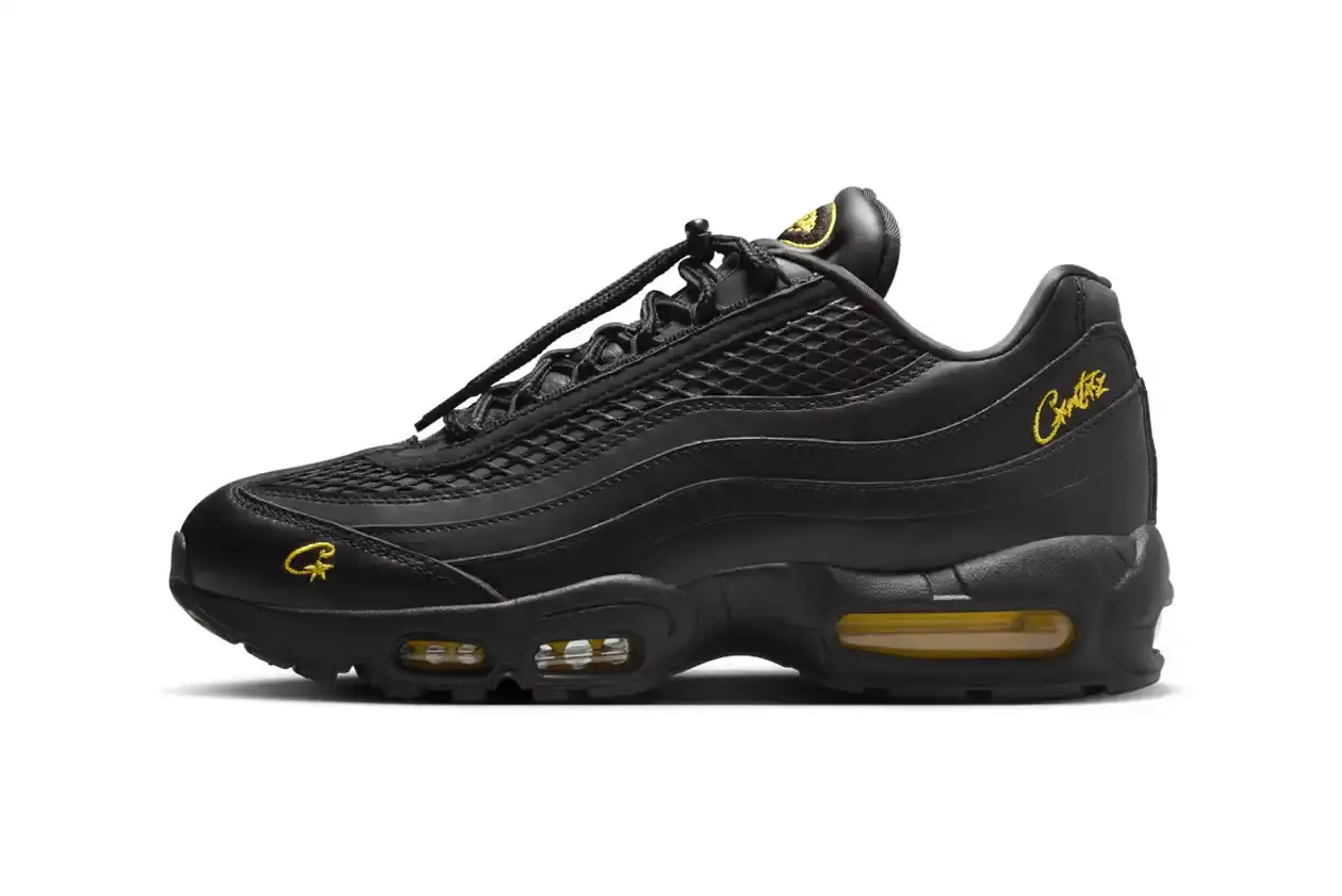 Nike Corteiz x Nike Air Max 95 'Honey Black' sneaker featuring an all-black premium leather upper with contrasting Tour Yellow accents on the branding and Air cushioning units. The sleek design showcases Corteiz branding on the lateral toe, heel, tongue and outsole, with London coordinates visible on the heel. The shoe maintains the Air Max 95's signature layered construction with mesh detailing on the upper. (image 2 of 8)