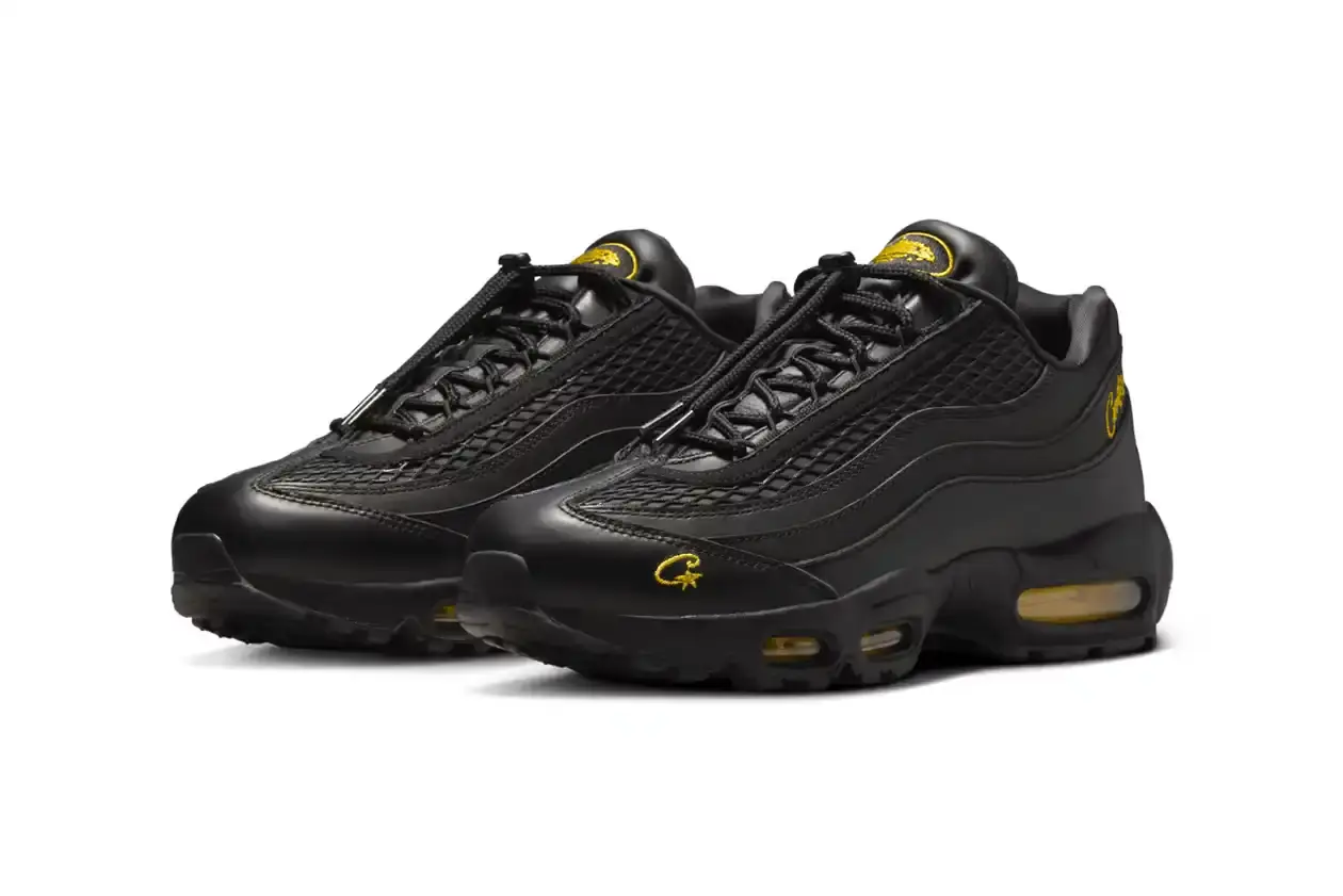 Nike Corteiz x Nike Air Max 95 'Honey Black' sneaker featuring an all-black premium leather upper with contrasting Tour Yellow accents on the branding and Air cushioning units. The sleek design showcases Corteiz branding on the lateral toe, heel, tongue and outsole, with London coordinates visible on the heel. The shoe maintains the Air Max 95's signature layered construction with mesh detailing on the upper. (image 4 of 8)