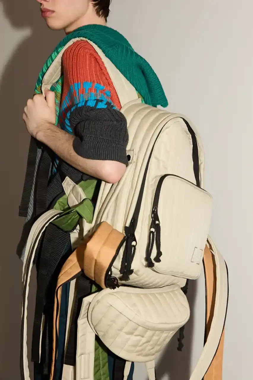 Eastpak Craig Green x Eastpak collection featuring quilted bags in black, khaki and navy with distinctive vertical stitching and modified logo patches.