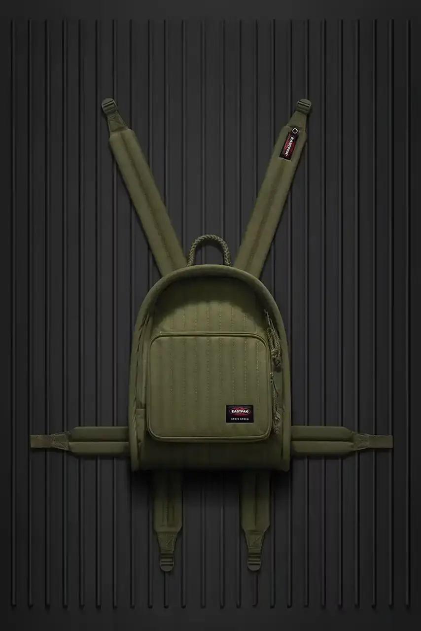 Eastpak Craig Green x Eastpak collection featuring quilted bags in black, khaki and navy with distinctive vertical stitching and modified logo patches. (image 3 of 7)