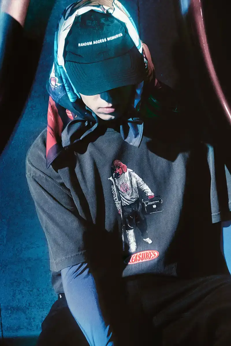 DAFT PUNK TEAMS UP WITH PLEASURES FOR NEW CAPSULE image about fashion collaboration between electronic music duo Daft Punk and streetwear brand PLEASURES. Features clothing and accessories incorporating the musicians' robot helmet imagery, album artwork, and references to their music videos and films. Collection includes hoodies, jackets, jeans, and accessories available July 16, 2025. (image 15 of 28)