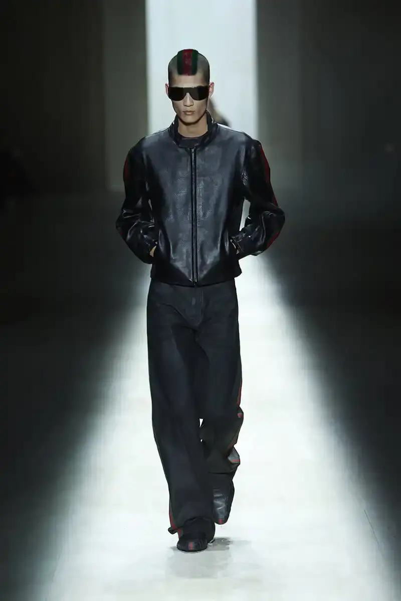 DEMNA'S FIRST GUCCI COLLECTION ARRIVES IN MILAN Demna Gvasalia's first Gucci collection runway show in Milan, featuring seamless garments, tracksuits, and the Manhattan sneaker. (image 17 of 32)